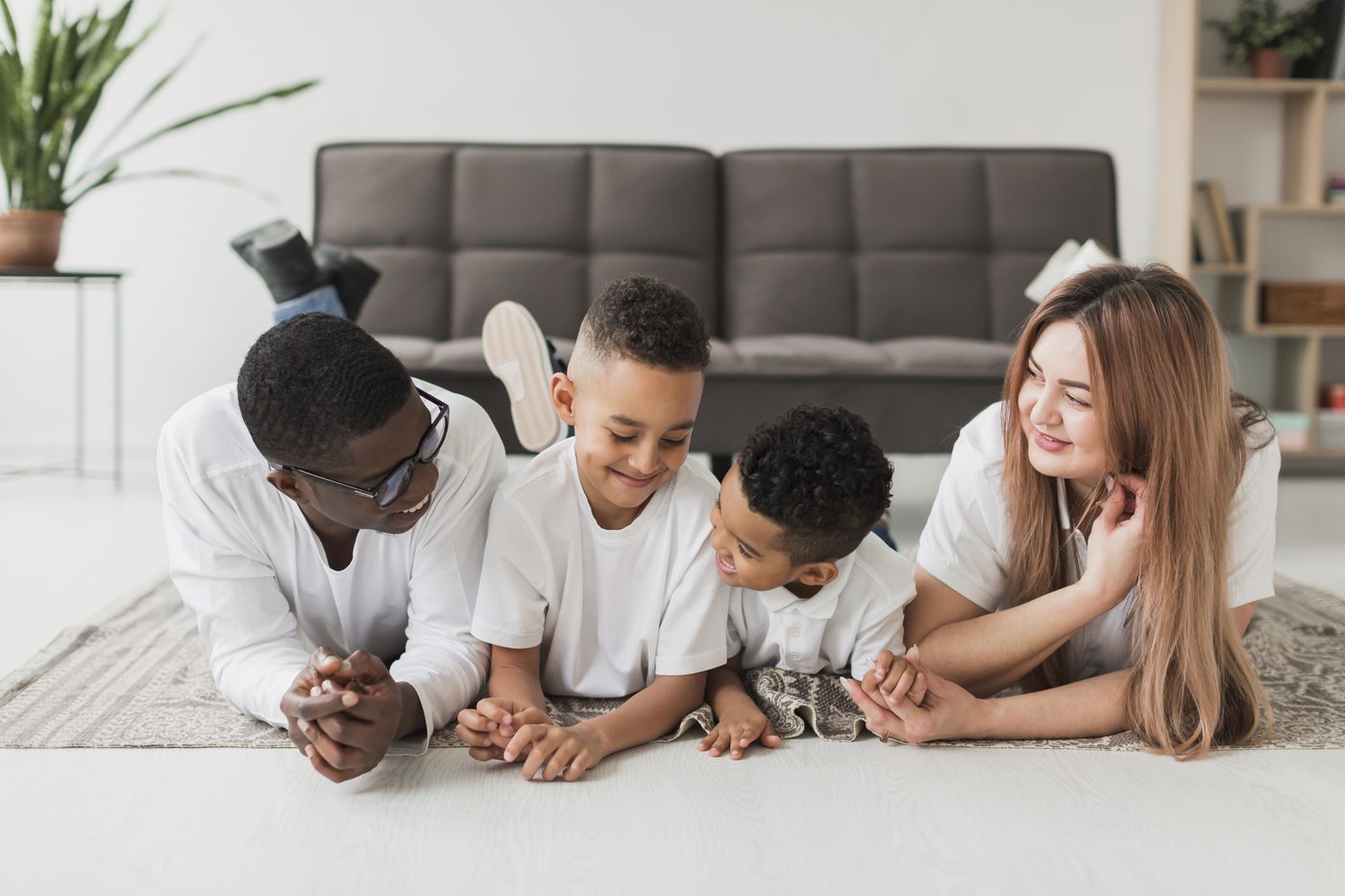A family relaxing together on the living room floor